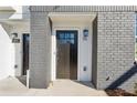 Close-up of modern townhome entrance with stylish black door and visible house number at 310 Mcdonough Se Blvd # 101, Atlanta, GA 30315