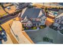 Overhead view of a brick home with a long driveway and an in-ground pool in the backyard at 3538 Lily Magnolia Ct, Buford, GA 30519