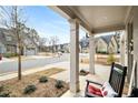 Relaxing front porch featuring classic rocking chairs with a view of the neighborhood street at 5229 Noble Village Way, Lilburn, GA 30047