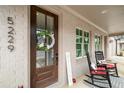 Inviting front porch with rocking chairs, brick facade, and seasonal wreath adorning the front door at 5229 Noble Village Way, Lilburn, GA 30047