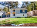 Beautiful two-story home showcasing a well-manicured lawn, lovely landscaping, and modern exterior finishes at 1270 Graymont Sw Dr, Atlanta, GA 30310
