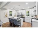 Bright eat-in kitchen features an island with seating, modern stainless appliances, and white cabinetry at 1270 Graymont Sw Dr, Atlanta, GA 30310