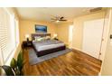 Bright bedroom featuring hardwood floors, a ceiling fan, and a comfortable king-sized bed at 1975 Glenmar Dr, Decatur, GA 30032