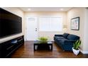 Cozy living room with modern decor, hardwood floors, and natural light from the window at 1975 Glenmar Dr, Decatur, GA 30032