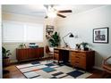 Stylish home office with wooden desk, a modern area rug and plenty of natural light at 1975 Glenmar Dr, Decatur, GA 30032
