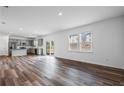 Open-concept living room with hardwood floors, stainless steel appliances, and sliding doors to the backyard at 3071 Birdsong Ave, Covington, GA 30016