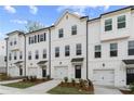 New townhome exteriors with integrated garages, black accents and manicured lawns at 3160 Washburn Sw St, Atlanta, GA 30354