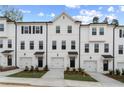 Modern townhomes showcase a uniform design with white exteriors and well-kept landscaping at 3160 Washburn Sw St, Atlanta, GA 30354