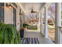 Inviting front porch with swing, columns, and decor creating a relaxing outdoor space at 3345 Highgate Hills Ne Dr, Duluth, GA 30097