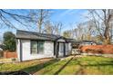 Angle view of a beautiful home featuring a well-manicured lawn and stylish black-and-white trim at 884 N Eugenia Nw Pl, Atlanta, GA 30318