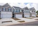 New townhomes feature attached garages, colorful siding, and a picturesque street at 1027 Northfield Dr, Conyers, GA 30013