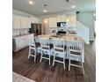 Spacious kitchen with granite countertops, a large island with barstool seating, and stainless steel appliances at 1027 Northfield Dr, Conyers, GA 30013