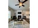 Cozy living area with fireplace, built-in shelving, modern decor, and an accent rug at 1027 Northfield Dr, Conyers, GA 30013