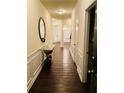 Elegant entryway featuring hardwood floors, decorative wainscoting, and stylish console table at 2463 Turnbury Glen, Snellville, GA 30078