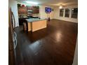 Open-concept kitchen with an island, dark cabinets, and stainless steel appliances at 2463 Turnbury Glen, Snellville, GA 30078