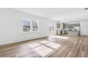 Bright, open-concept living room with wood floors connecting to the kitchen, perfect for entertaining at 3639 Olive Grove Ln, Covington, GA 30016