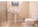 Bright bathroom features modern sink, toilet, and a glass-enclosed shower with tile surround at 1133 Church Se St # 2, Covington, GA 30014