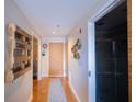 Hallway with bathroom, laundry and front door, featuring a decorative pallet and geometric wine rack at 1133 Church Se St # 2, Covington, GA 30014