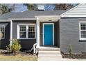 Close up of a gray brick house with a bright blue front door and clean white trim at 1802 S Gordon Sw St, Atlanta, GA 30310