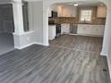 Modern kitchen with stainless steel appliances, white cabinets, and stone countertops at 5718 Denson Blvd, Morrow, GA 30260
