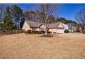 Attractive single-story home featuring a spacious front yard, an attached two-car garage, and tidy landscaping at 7350 Brassfield Dr, Cumming, GA 30041