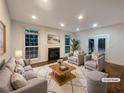 Staged living room with a cozy fireplace, plush seating, and bright natural light at 175 Stillwood Dr, Fayetteville, GA 30215