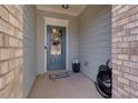 Cozy front porch featuring decorative brick and a blue front door with glass panels at 5620 Berney Cir, Powder Springs, GA 30127