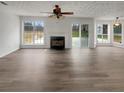 Spacious living room with fireplace, large windows and neutral decor at 7782 Wethersfield Dr, Jonesboro, GA 30236