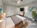Serene bedroom featuring a tray ceiling, soft lighting, and ensuite access at 7782 Wethersfield Dr, Jonesboro, GA 30236