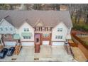 Aerial view of a townhome complex featuring multiple units, private garages, and well-maintained landscaping at 4288 Buford Valley Way, Buford, GA 30518