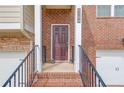 A welcoming front door with brick facade, elegant house number, and twin lanterns, exudes curb appeal and charm at 4288 Buford Valley Way, Buford, GA 30518