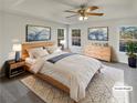 Serene main bedroom showcasing neutral tones, tray ceilings, and natural light at 62 Bishop Mill Nw Dr, Cartersville, GA 30121