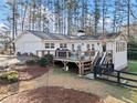 Backyard featuring a spacious wooden deck, perfect for outdoor dining and entertaining at 1405 Roper Rd, Canton, GA 30115