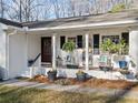 Inviting front porch with rocking chairs, hanging ferns, and cottage style decor at 1405 Roper Rd, Canton, GA 30115