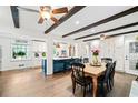 Bright living room with hardwood floors, beam ceiling, and open to kitchen island at 1405 Roper Rd, Canton, GA 30115