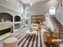 Bright living room featuring a fireplace, a large window, and stylish furniture at 2708 Stockbridge Way, Dacula, GA 30019