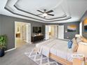 Spacious main bedroom with tray ceilings, a ceiling fan, and multiple closets at 2708 Stockbridge Way, Dacula, GA 30019
