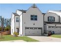 Charming two-story home featuring a white brick facade and a two-car garage at 1733 Hyssop Blvd, Mableton, GA 30126