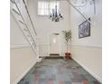 Welcoming hallway with slate tile floor, chandelier, and white staircase at 6851 Roswell Rd # H1, Sandy Springs, GA 30328