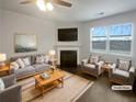 Bright, staged living room with a fireplace, large windows, and comfortable seating at 1260 Brookstone Cir, Conyers, GA 30012