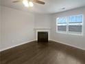 Cozy living room featuring a classic fireplace and a window with natural light at 1260 Brookstone Cir, Conyers, GA 30012