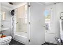 Bathroom with a sink, toilet, shower/tub combo, and a window for natural light at 207 Taylor Cir, Palmetto, GA 30268