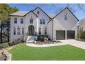 Beautiful two-story home featuring a brick facade, well-manicured lawn, and a two-car garage at 340 Willow Crescent Way, Johns Creek, GA 30022