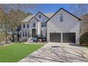 Attractive two-story home featuring a brick facade, well-manicured lawn, and a two-car garage at 340 Willow Crescent Way, Johns Creek, GA 30022