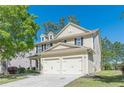 Lovely exterior view of a two-story home featuring a two-car garage and well-maintained landscaping at 4310 Alysheba Dr, Fairburn, GA 30213