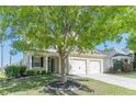 Attractive two-story home with a two-car garage and a lush tree in the front yard offering shade at 4310 Alysheba Dr, Fairburn, GA 30213