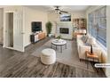 Cozy living room with a fireplace, modern furniture, and ample natural light from the large windows at 1997 Alcovy Trace Way, Lawrenceville, GA 30045