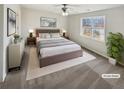 Inviting main bedroom featuring soft neutral tones, large windows, and a comfortable bed at 122 Sanders Walk, Mcdonough, GA 30252