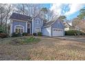 Beautiful two-story blue home with a two-car garage and lovely front yard landscaping at 2910 Mitchell Ne Cv, Brookhaven, GA 30319