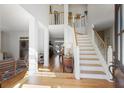 Spacious foyer with hardwood floors, staircase, and views into the living room, providing a welcoming entrance at 685 Trailwood Sw Ln, Marietta, GA 30064